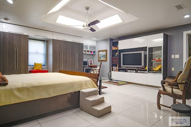 bedroom with ceiling fan and light tile patterned floors