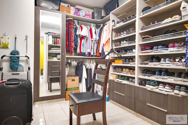 spacious closet featuring light tile patterned floors