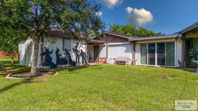 back of house featuring central AC unit and a yard