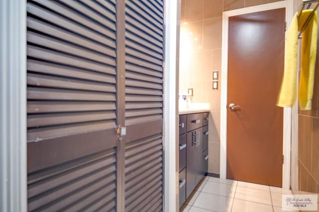 bathroom with tile patterned floors and tile walls