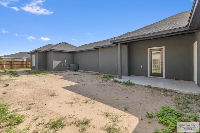 9718 Alexis Ave, Harlingen, TX 78550 - back of house featuring a patio, fence, roof with shingles, and stucco siding