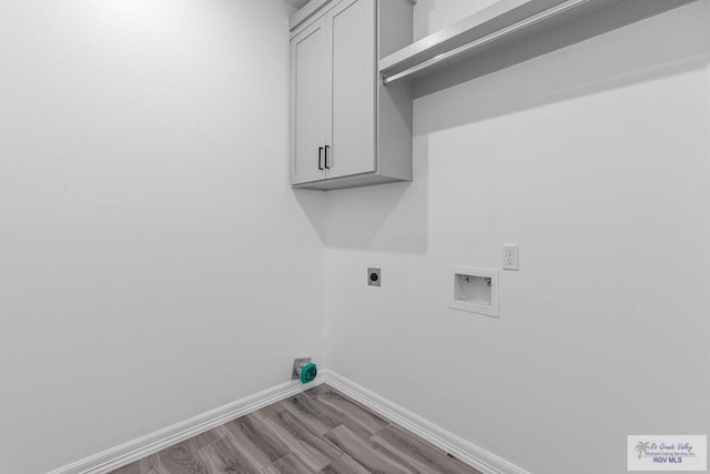 9718 Alexis Ave, Harlingen, TX 78550 - laundry room featuring washer hookup, baseboards, wood finished floors, hookup for an electric dryer, and cabinet space