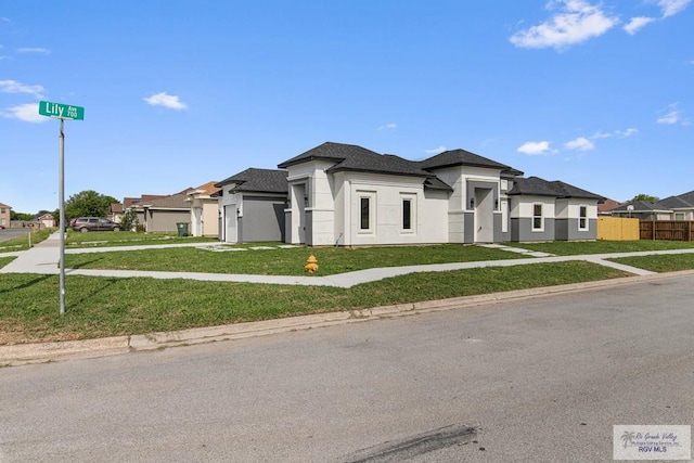 9718 Alexis Ave, Harlingen, TX 78550 - prairie-style house with a front lawn, a residential view, and fence