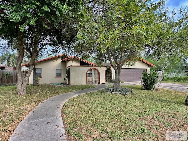 view of front facade featuring a front yard and a garage