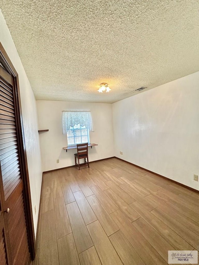 interior space with hardwood / wood-style floors and a textured ceiling