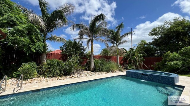 5443 Autumn Mist Ln, Brownsville, TX 78526 - view of swimming pool with a fenced backyard and a pool with connected hot tub