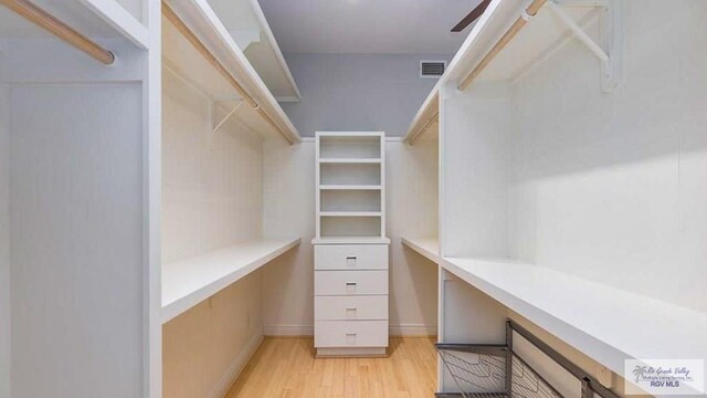 5443 Autumn Mist Ln, Brownsville, TX 78526 - spacious closet featuring built in study area and light wood-style flooring