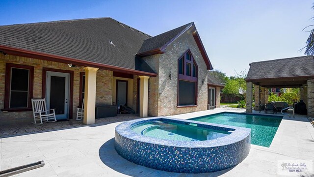 5443 Autumn Mist Ln, Brownsville, TX 78526 - view of pool with a patio area and a pool with connected hot tub