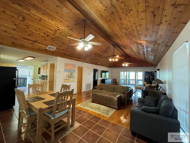 interior space featuring vaulted ceiling with beams, ceiling fan, dark tile patterned floors, and wood ceiling