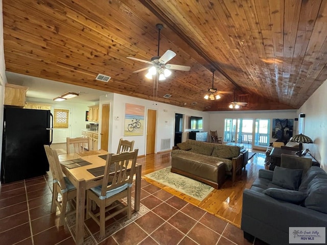 dining room with wood ceiling, ceiling fan, dark tile patterned floors, and lofted ceiling with beams