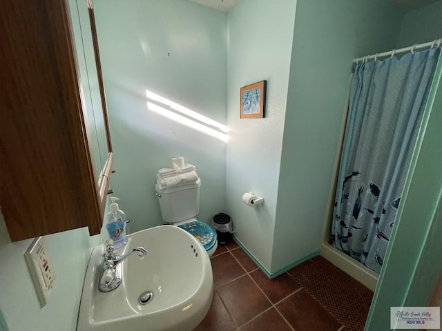 bathroom featuring tile patterned floors, curtained shower, and sink