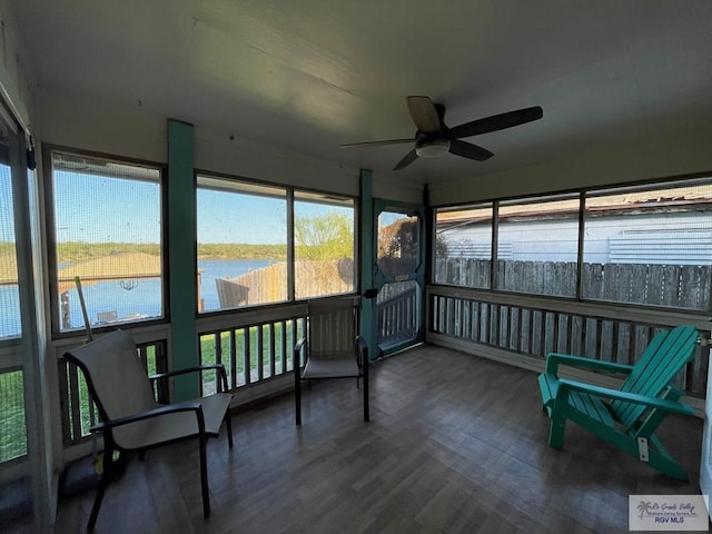 sunroom / solarium with ceiling fan, a water view, and a healthy amount of sunlight