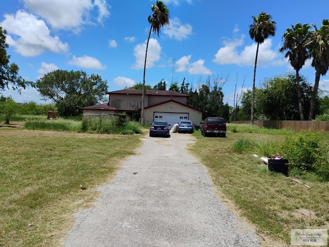 single story home featuring a front lawn and a garage