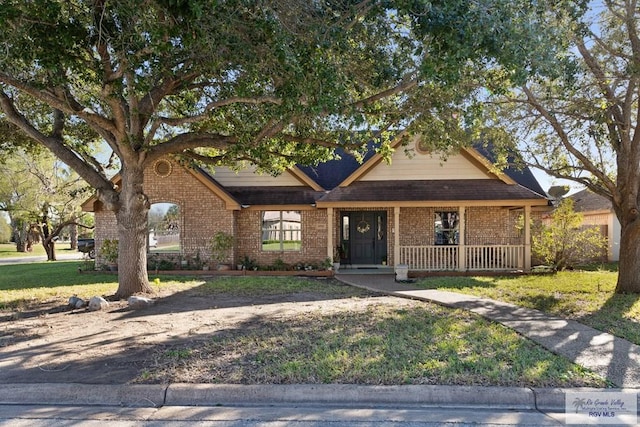 view of front facade with a front lawn and a porch