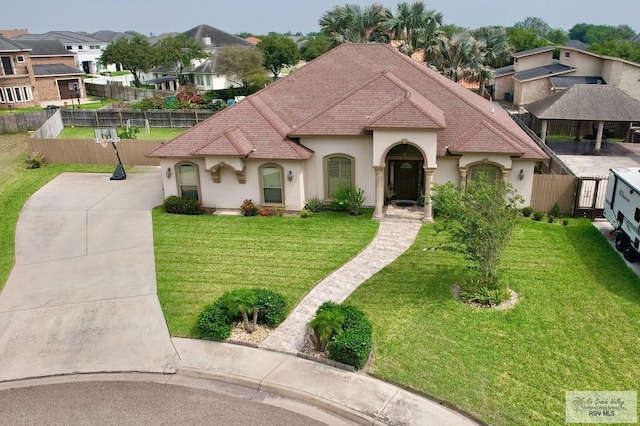 mediterranean / spanish house featuring a front yard