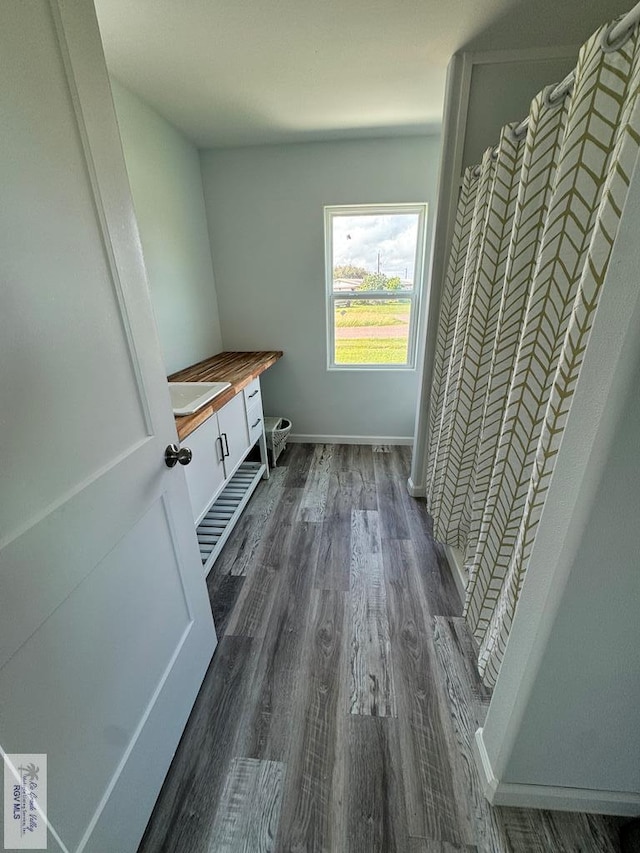 laundry room with dark hardwood / wood-style floors