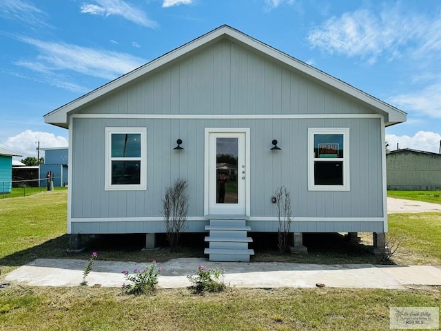 rear view of property with a lawn