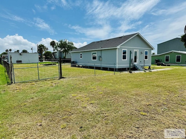 back of property featuring a lawn