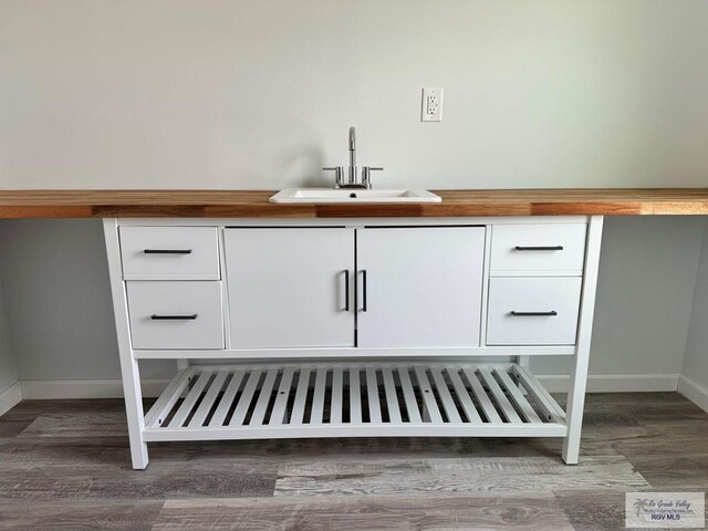 details featuring sink and hardwood / wood-style flooring