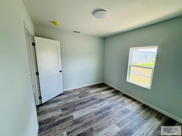 unfurnished room featuring hardwood / wood-style flooring