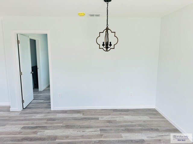 unfurnished dining area with light hardwood / wood-style flooring