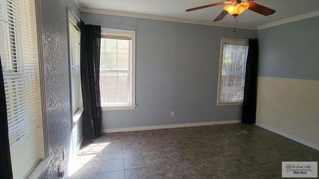 empty room featuring crown molding, tile patterned floors, and ceiling fan