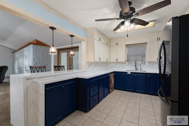 kitchen featuring black appliances, white cabinets, blue cabinets, decorative light fixtures, and kitchen peninsula