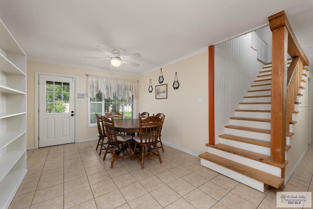 dining room with light tile patterned floors, ornamental molding, and ceiling fan