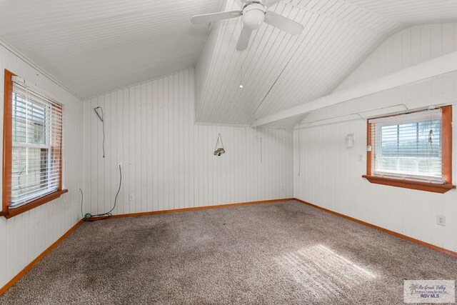 spare room featuring vaulted ceiling, ceiling fan, and carpet