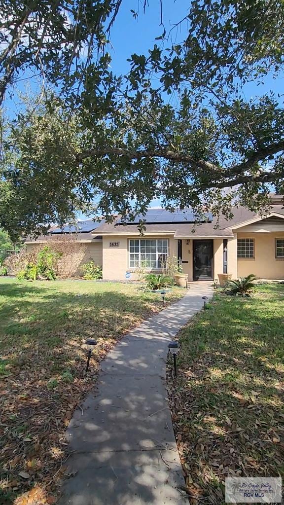 ranch-style house with a front lawn