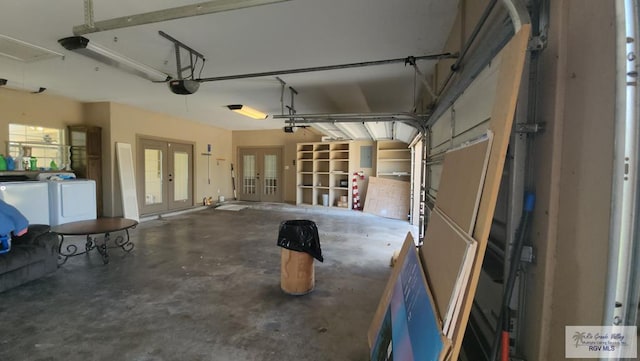 garage featuring a garage door opener, washer and dryer, and electric panel