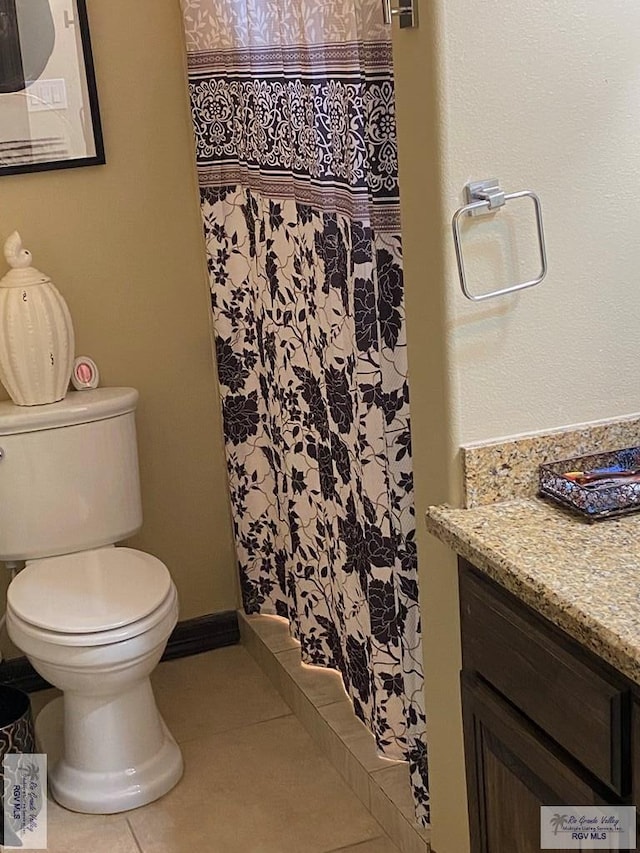 full bathroom with tile patterned flooring, curtained shower, baseboards, toilet, and vanity