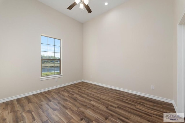 empty room with ceiling fan and dark hardwood / wood-style floors