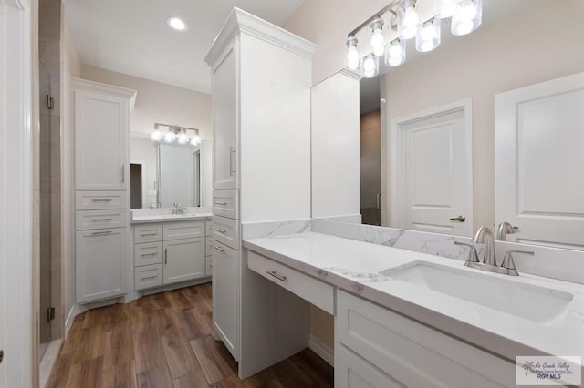 bathroom with hardwood / wood-style flooring and vanity