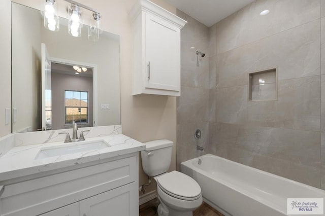 full bathroom with vanity, toilet, and tiled shower / bath combo