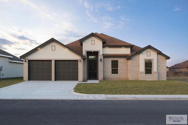 view of front of house featuring a garage and a front lawn