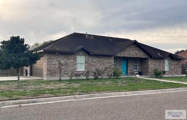 ranch-style house with a garage and a front yard