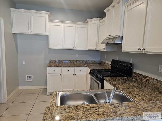 kitchen with black electric range, white cabinets, light tile patterned flooring, and sink