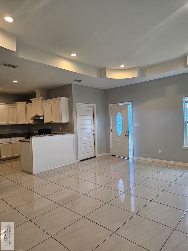 kitchen featuring white cabinetry and a wealth of natural light