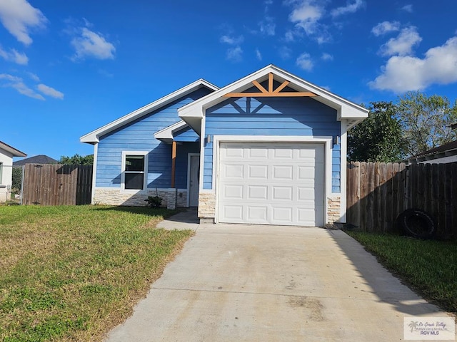 view of front of home with a front yard and a garage