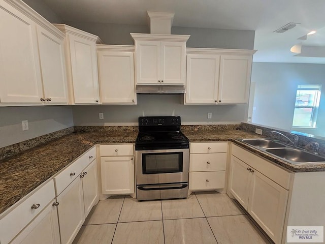 kitchen with sink, stainless steel electric range, dark stone countertops, white cabinetry, and light tile patterned flooring