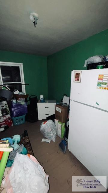 interior space with white fridge and hardwood / wood-style flooring