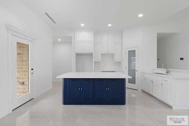 kitchen with white cabinetry and sink