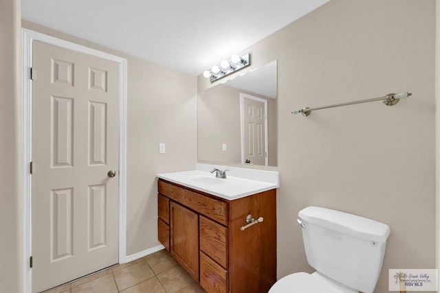 bathroom featuring toilet, tile patterned flooring, and vanity