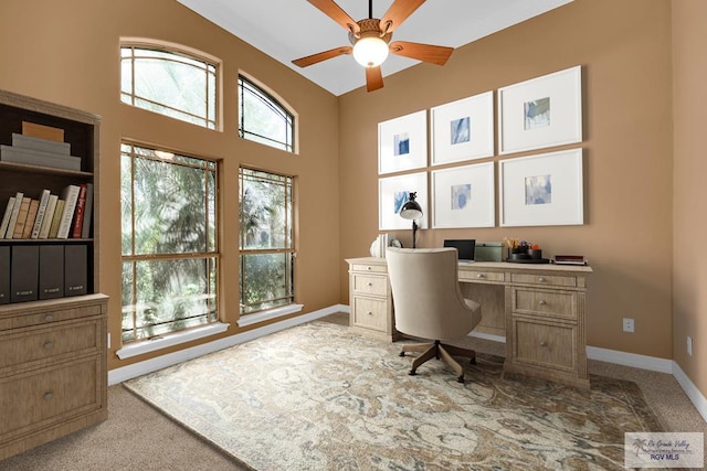 office with light carpet, a ceiling fan, and baseboards