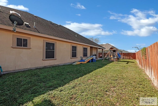 view of yard featuring a fenced backyard and a playground