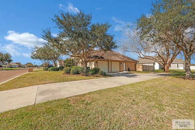 view of front of property featuring a garage, concrete driveway, and a front yard