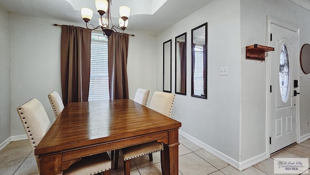 dining space featuring an inviting chandelier, baseboards, and light tile patterned flooring