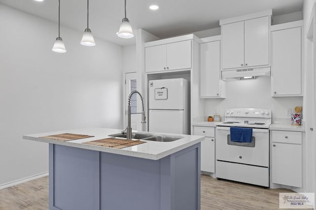 kitchen featuring white cabinets, white appliances, sink, and an island with sink