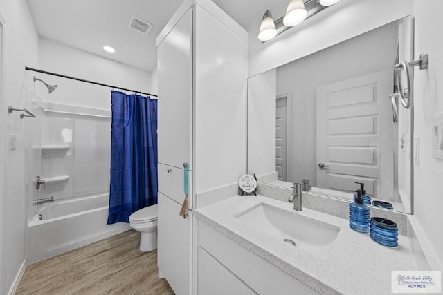 full bathroom featuring shower / bath combo with shower curtain, vanity, wood-type flooring, and toilet